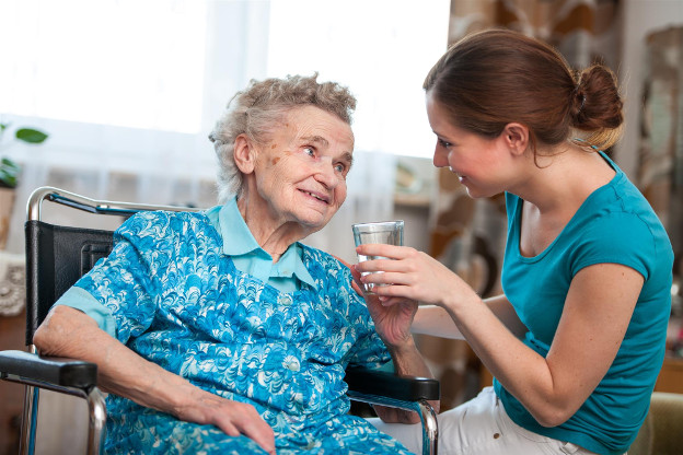 Helping elder lady with water