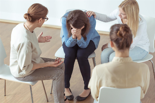 Family helping with grief in woman