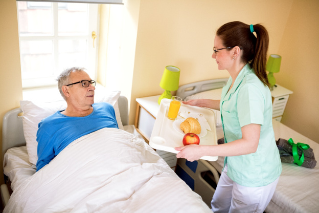 Patient getting food served in bed